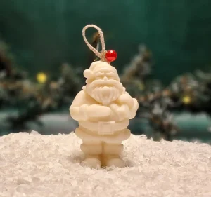 Handgemachte Sojawachskerze in Form eines weißen Weihnachtsmanns, verziert mit einer roten Perle am Band